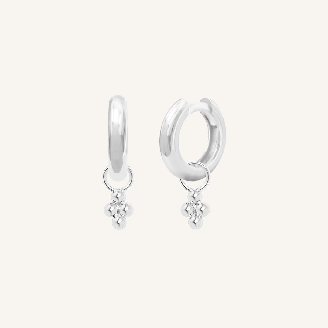 A pair of silver-tone hoop earrings with bobble details.