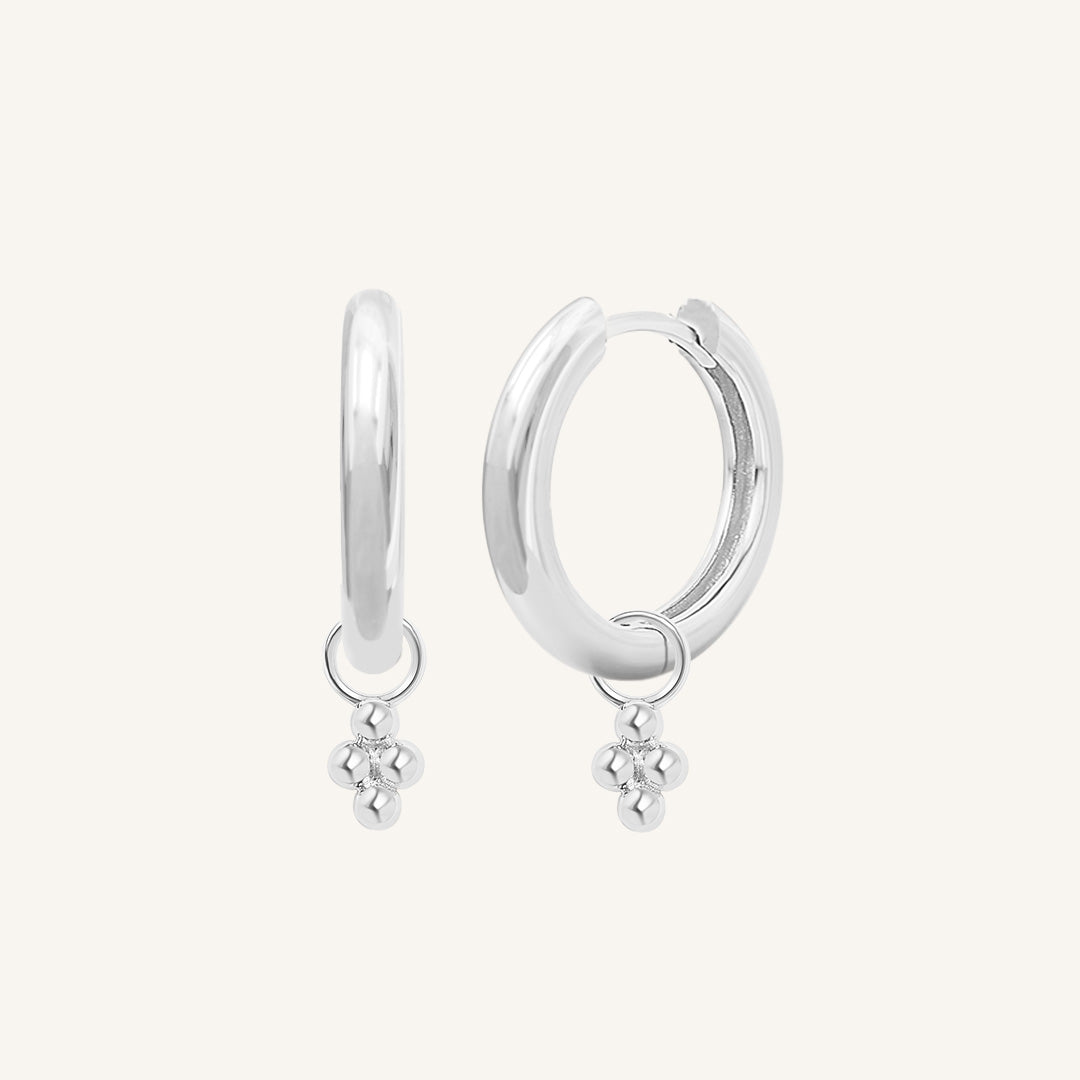 A pair of silver-tone hoop earrings with bobble details.