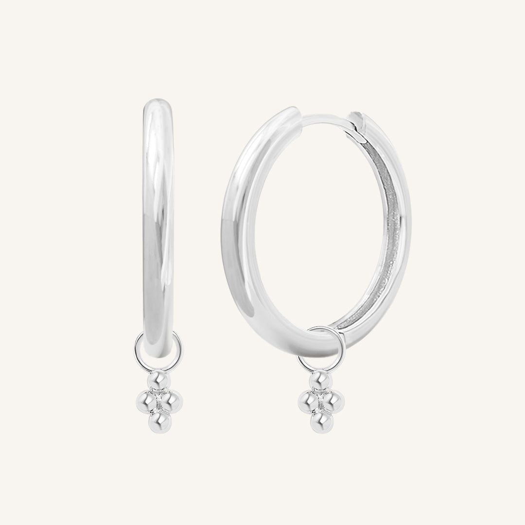 A pair of silver-tone hoop earrings with bobble details.