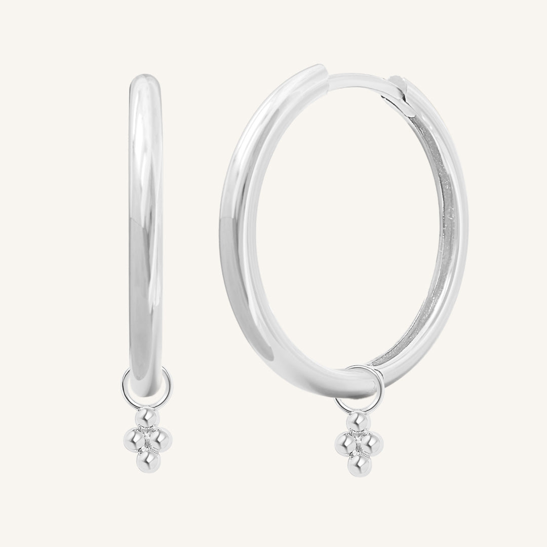 A pair of silver-tone hoop earrings with bobble details.
