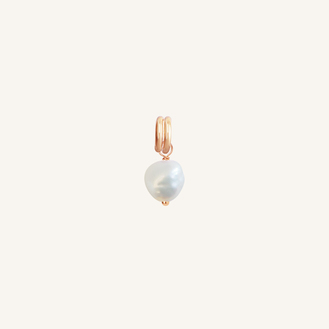 A petite pearl charm with rose findings