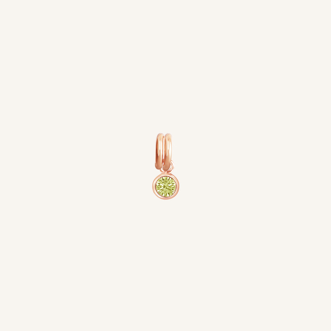 Rose Gold round charm with bezel-set peridot green cubic zirconia representing the August birthstone