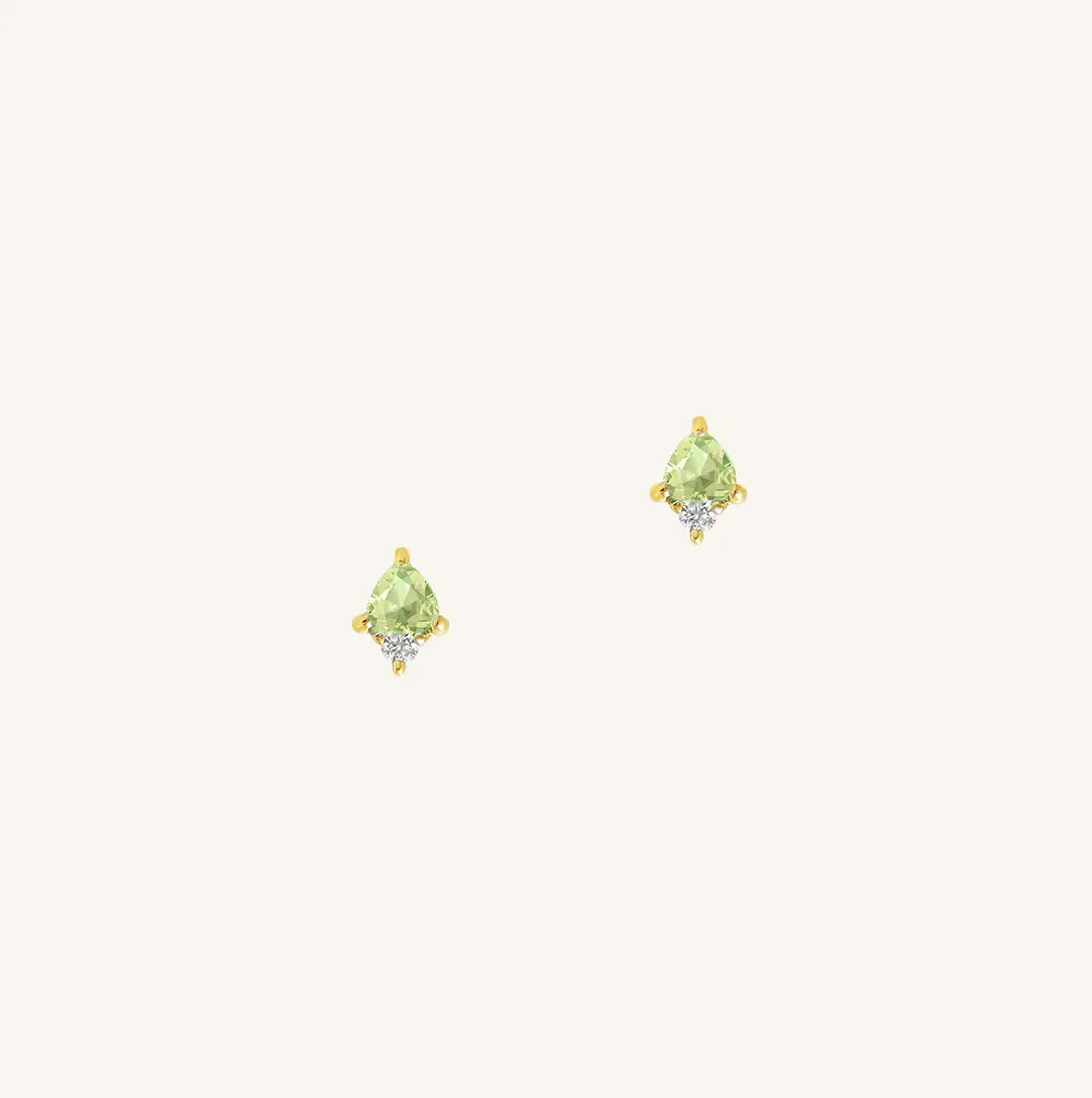 A gold pair of stud earrings featuring a green cubic zirconia, representing August.