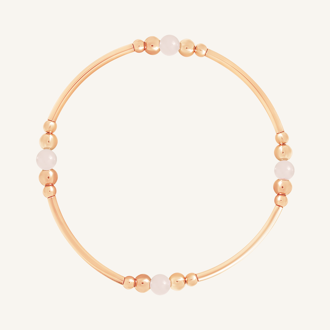 A rose-tone beaded bracelet with rose quartz stones