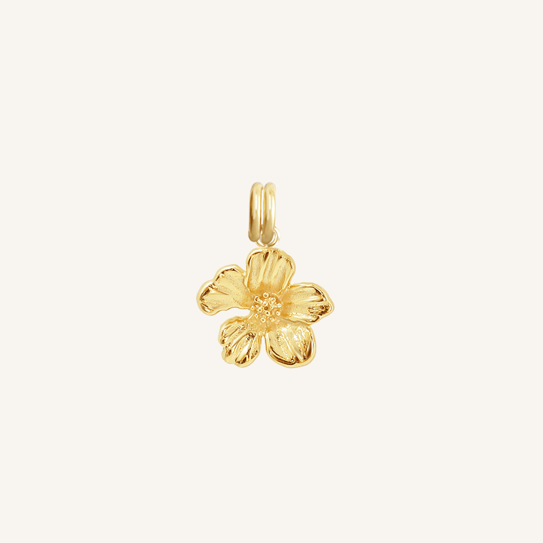 A gold-colored metal charm in the shape of an Azalea flower.
