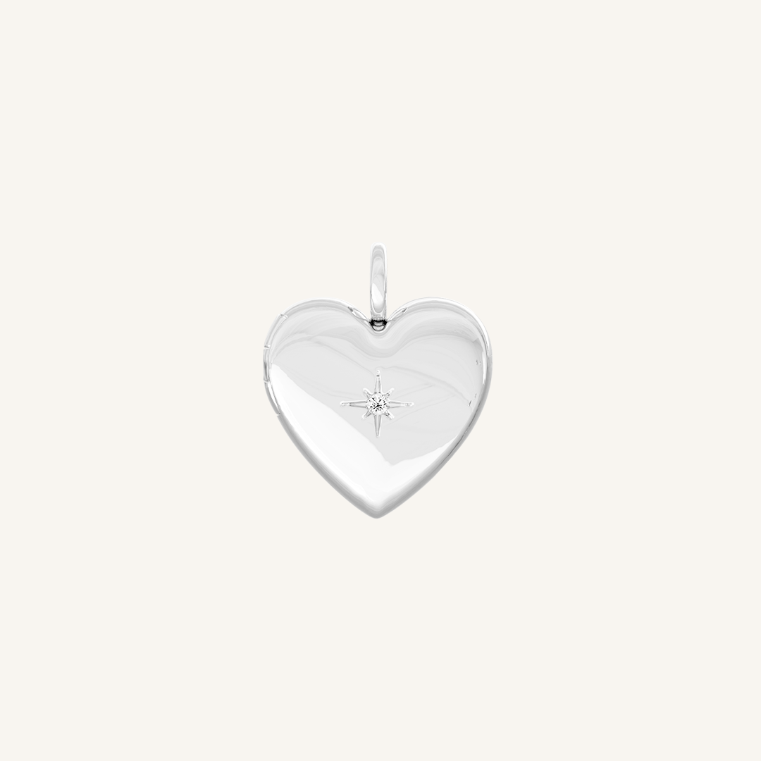 A silver heart-shaped photo locket closed close up
