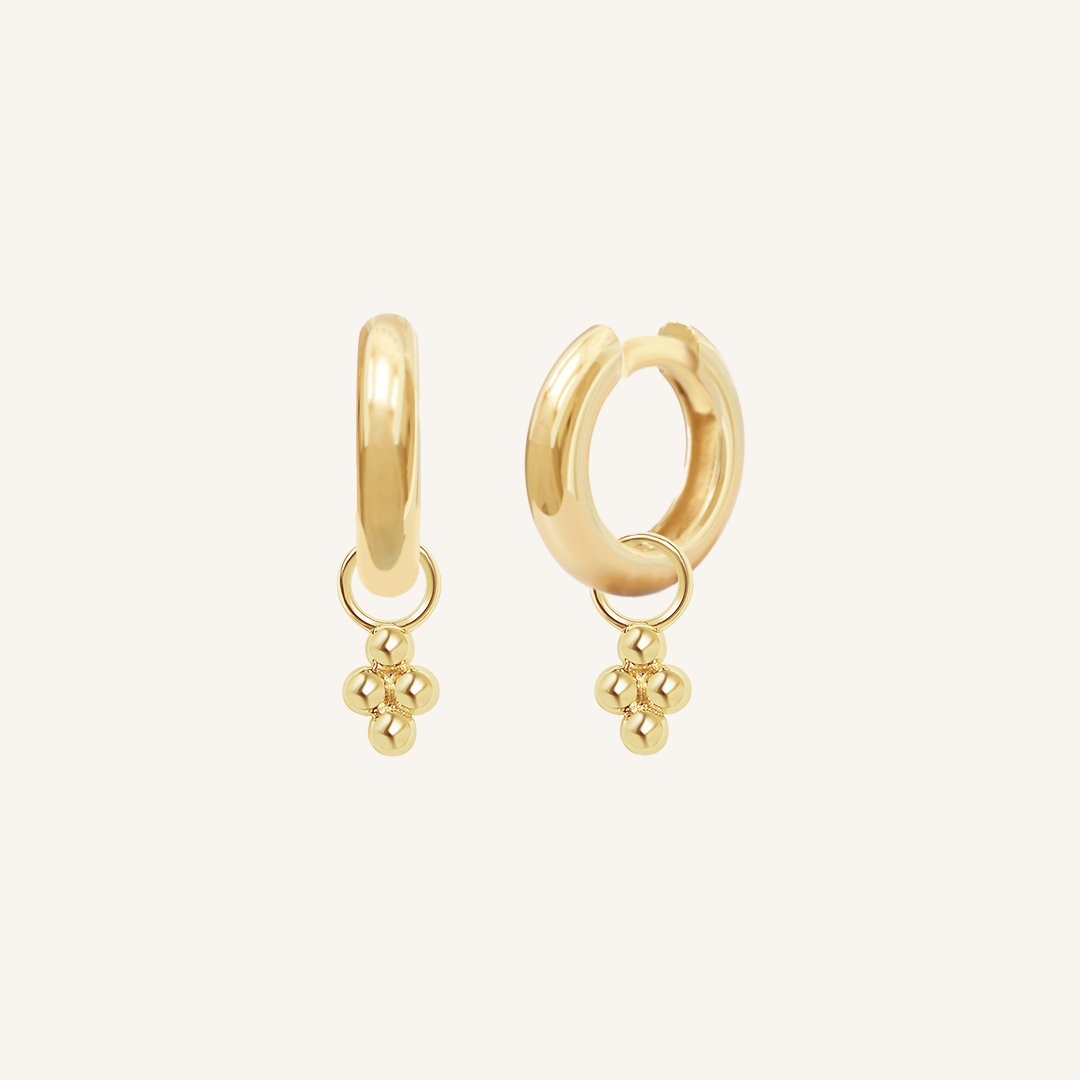 A pair of gold-tone hoop earrings with bobble details.