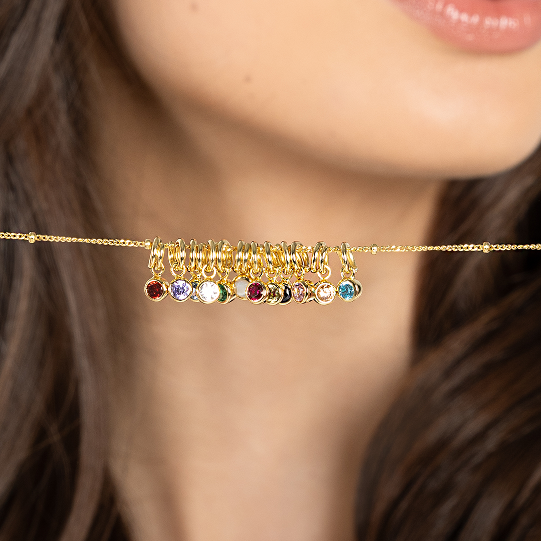 Round birthstone charms lined up from January to December on a chain