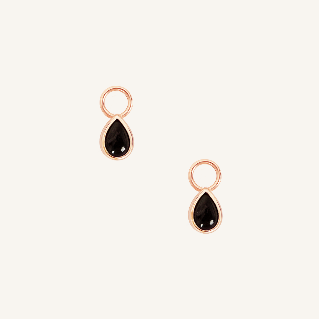 A set of two rose gold hoop charms with teardrop-shaped Black Onyx stones