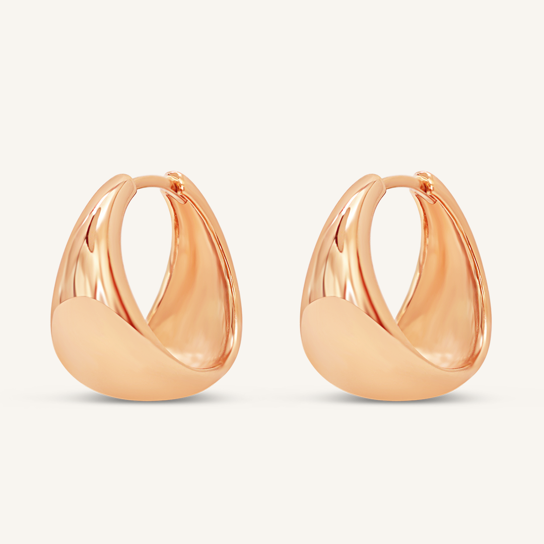 A pair of rose chunky hoop earrings on a white background.