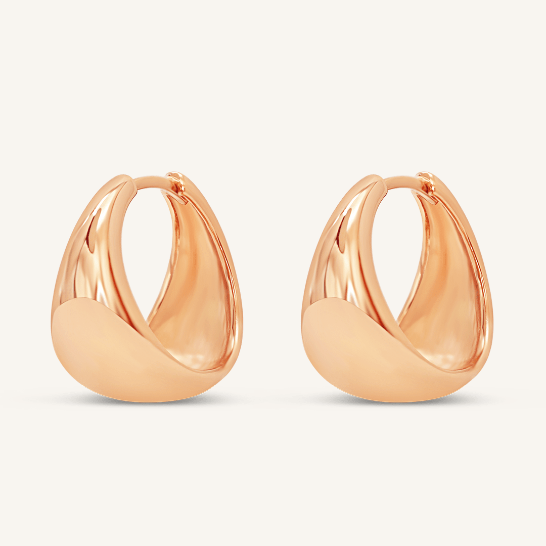 A pair of rose chunky hoop earrings on a white background.