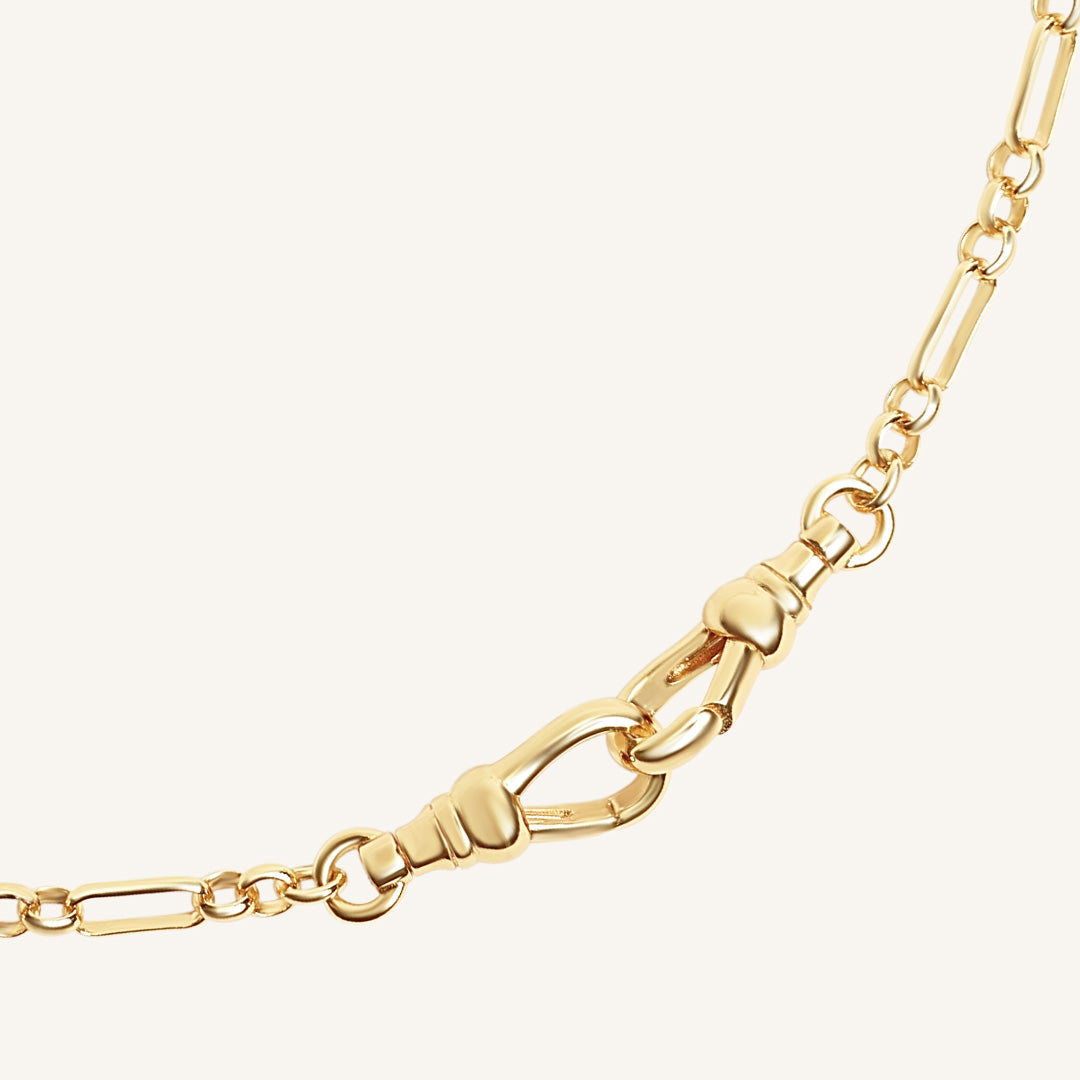Gold chain with a clasp on a white background