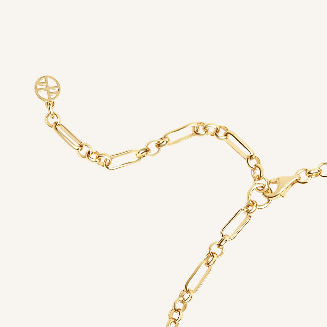 Gold chain bracelet on a white background
