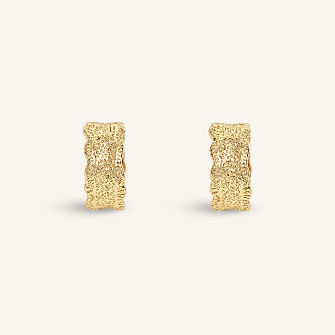 Gold hoop earrings on a white background