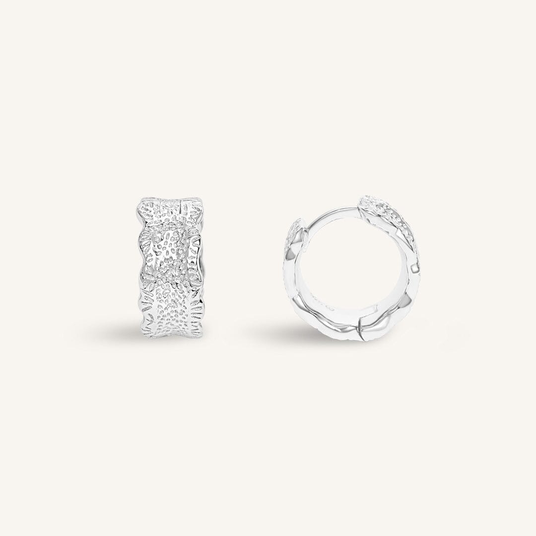 Silver hoop earrings on a white background