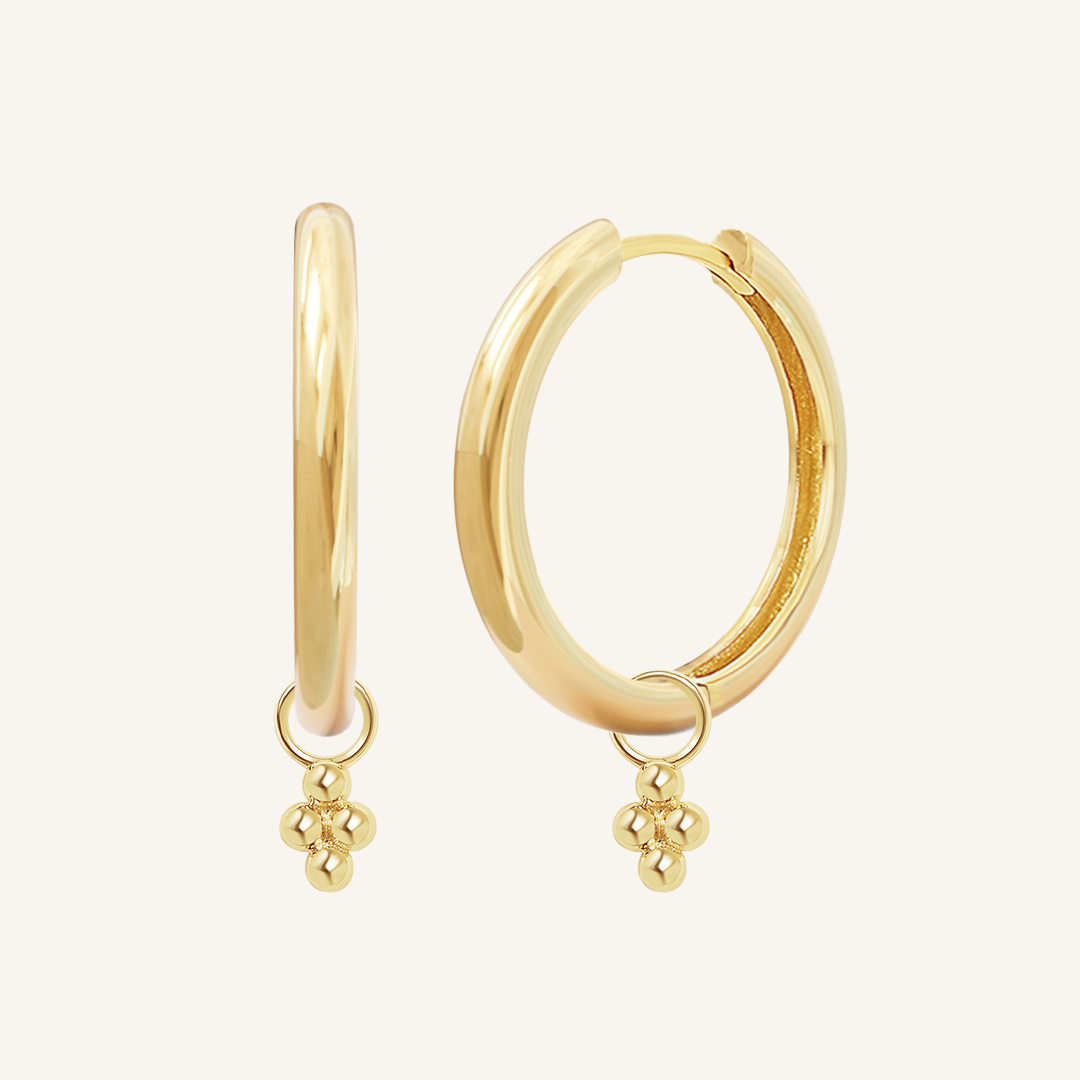 A pair of gold-tone hoop earrings with bobble details.