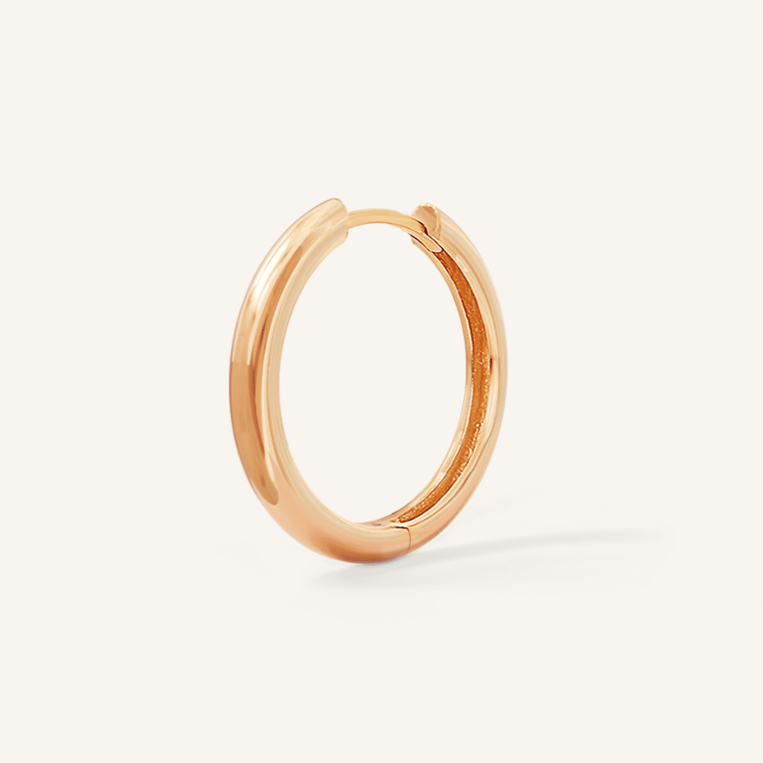 A rose hoop earring on a white background
