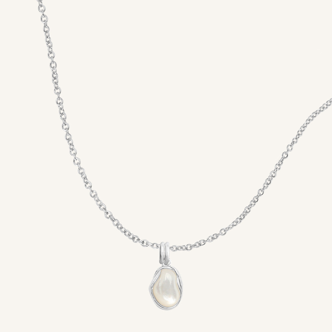 Necklace with a teardrop-shaped pendant on a light gray background
