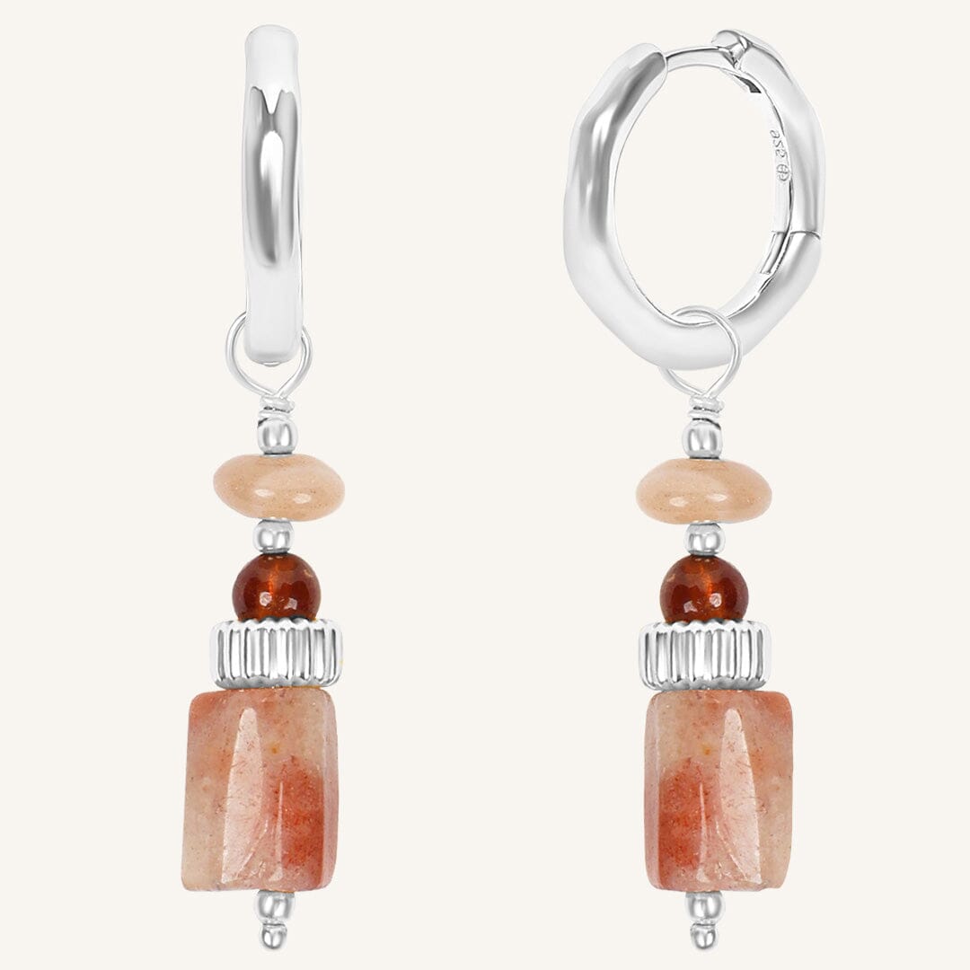 Pair of hoop earrings with stone beads on a white background