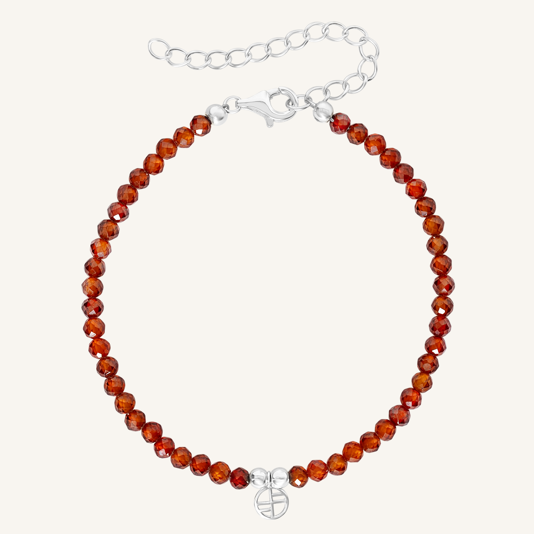 Bracelet with amber beads and a silver clasp on a white background