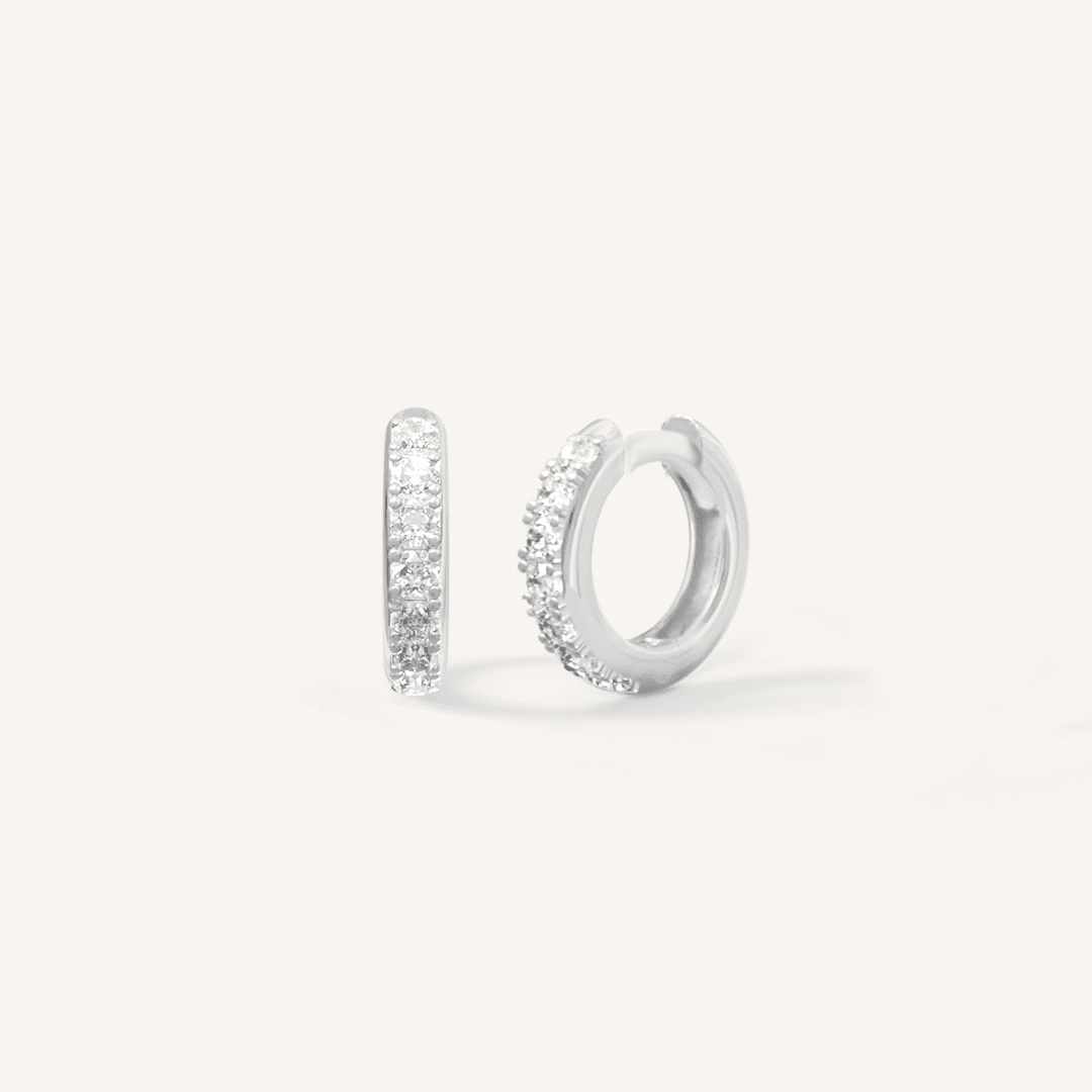 Small silver huggies, with cubic zirconias wrapped around