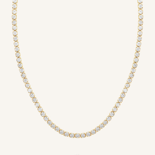 A tennis chain necklace with gold metal tone.