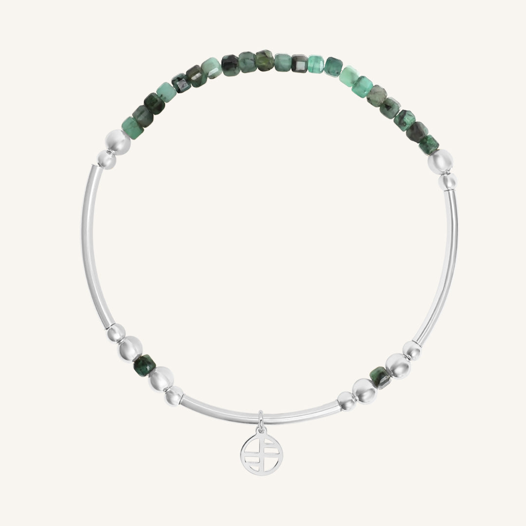Beaded bracelet with green and silver beads on a white background