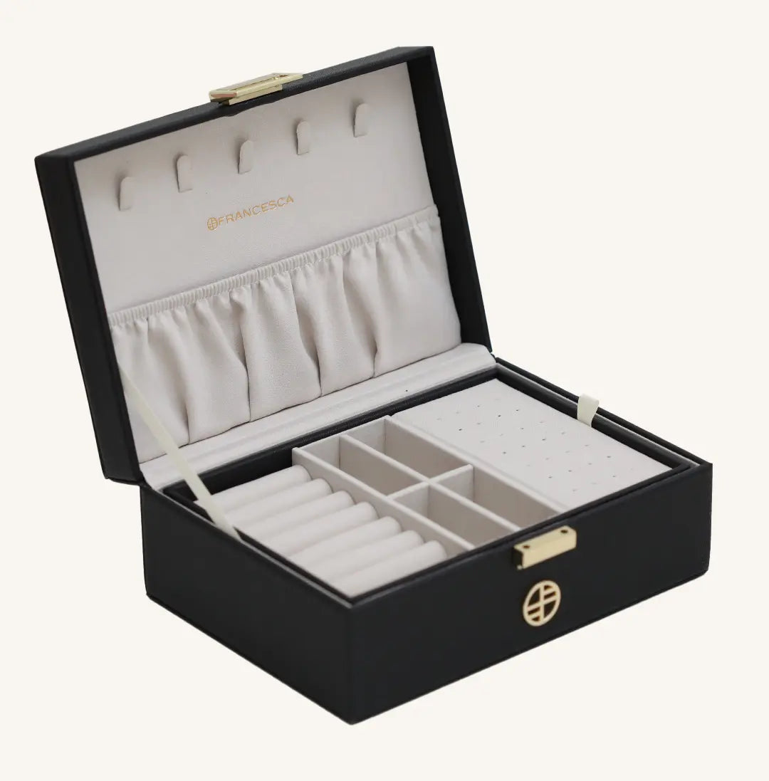 A black jewellery box with a lid, open sections for storing jewellery, and a necklace rack inside.