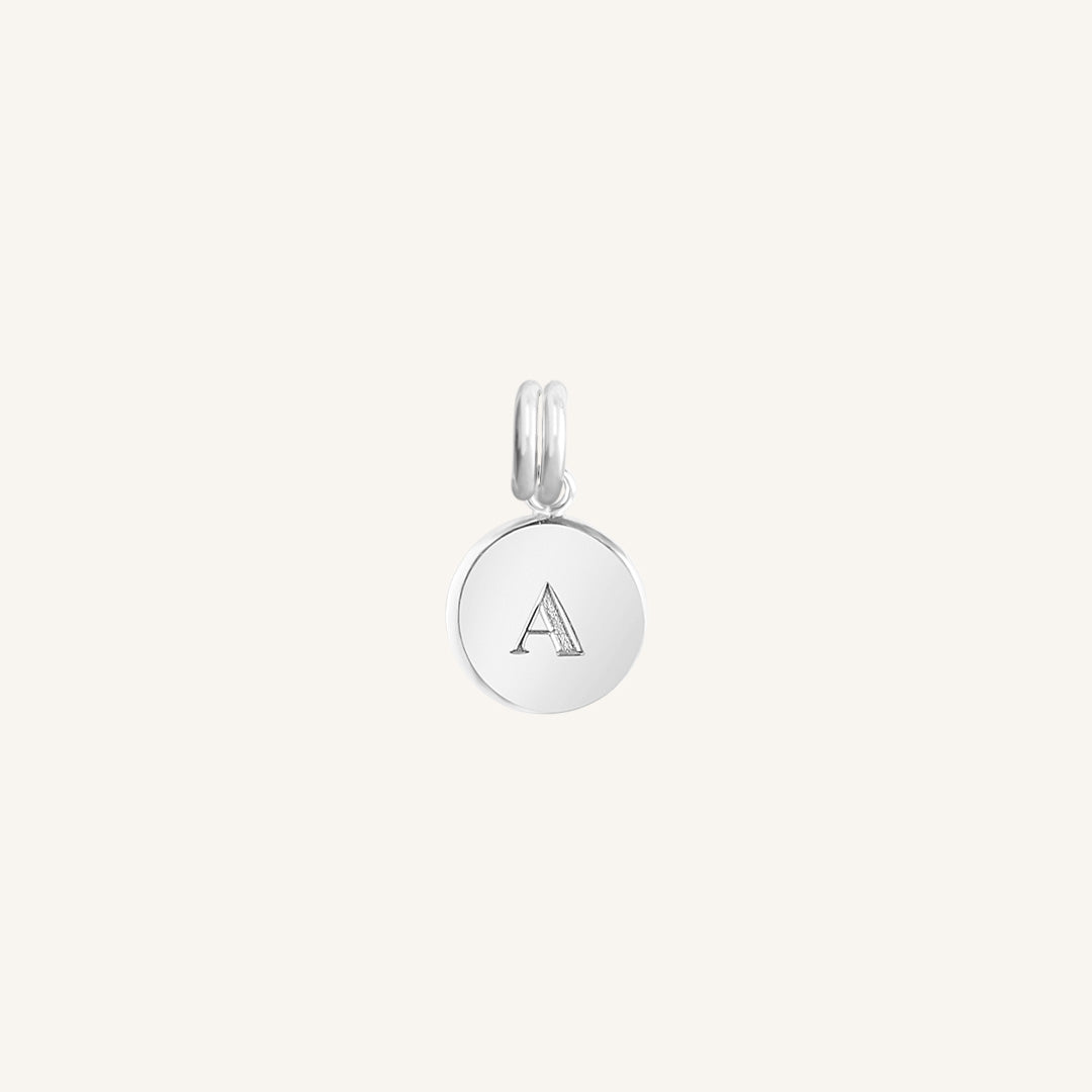 A silver round charm with the letter 'A' on it, presented against a white background.