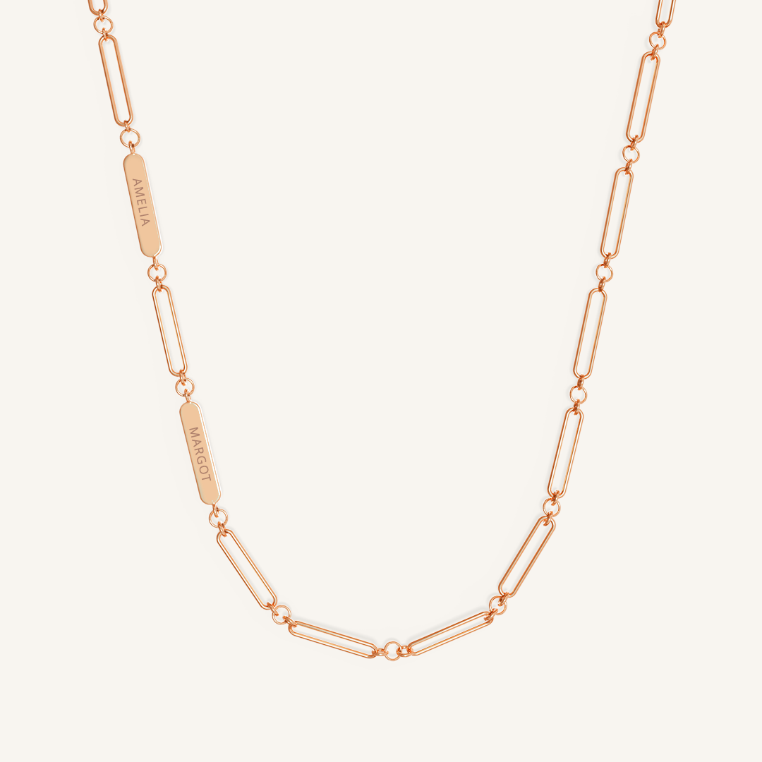 A rose chain necklace with two engraveable panels on a white background