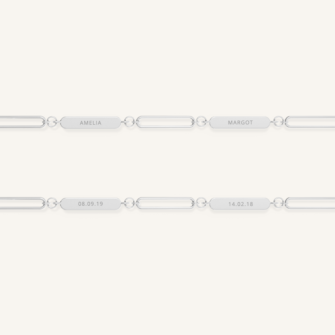 A silver chain necklace with two engraveable panels on a white background