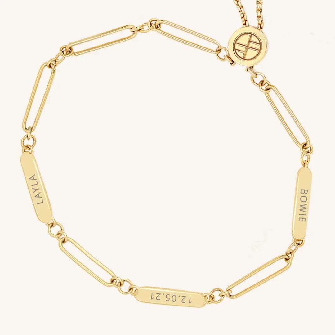 A gold Etch chain bracelet with three panels for engraving, featuring an adjustable fastening mechanism.