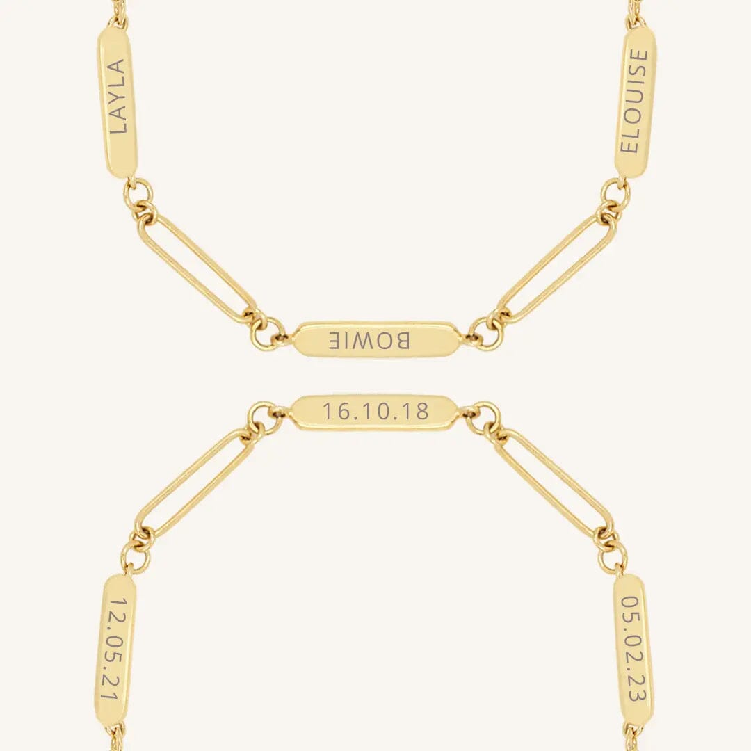 A gold Etch chain bracelet with three panels for engraving, close up