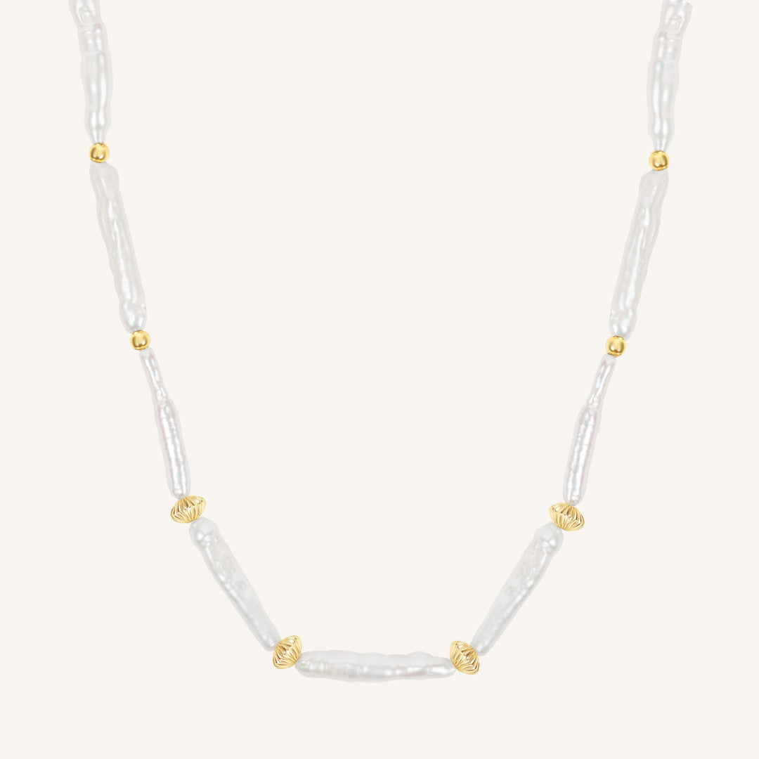 Necklace with white beads and gold accents on a white background