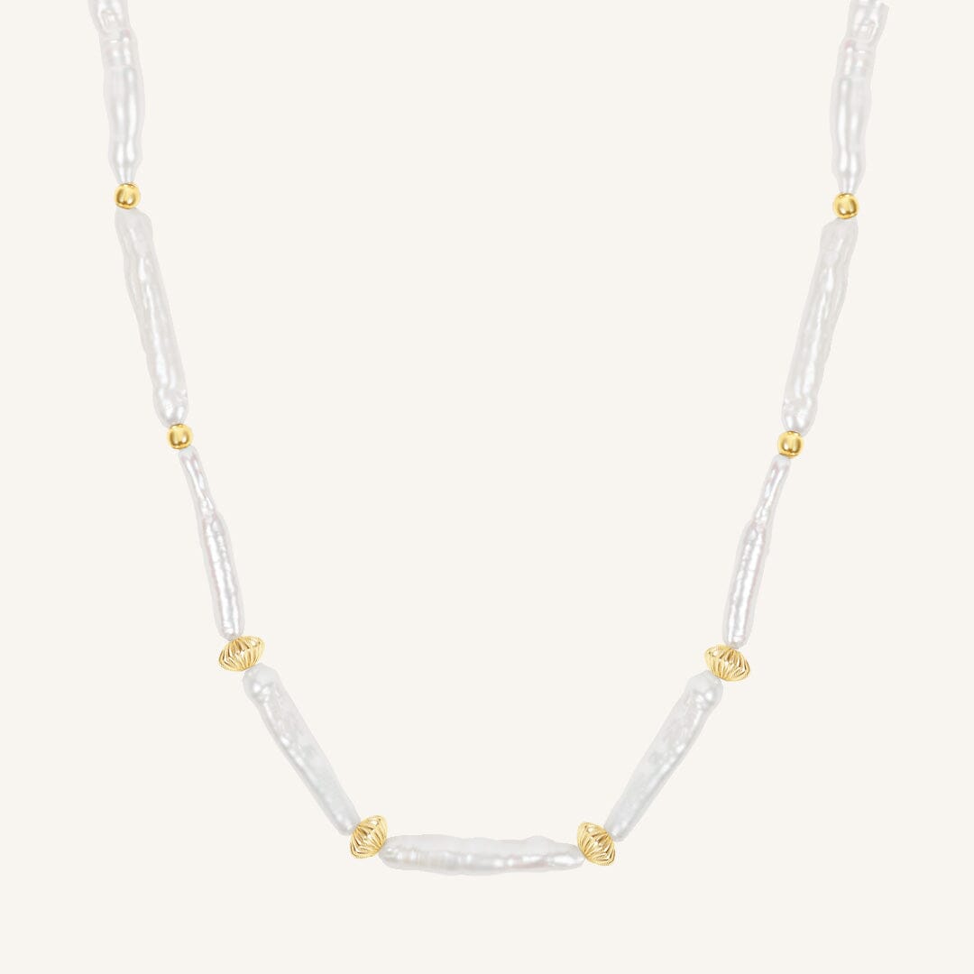 Necklace with white beads and gold accents on a white background