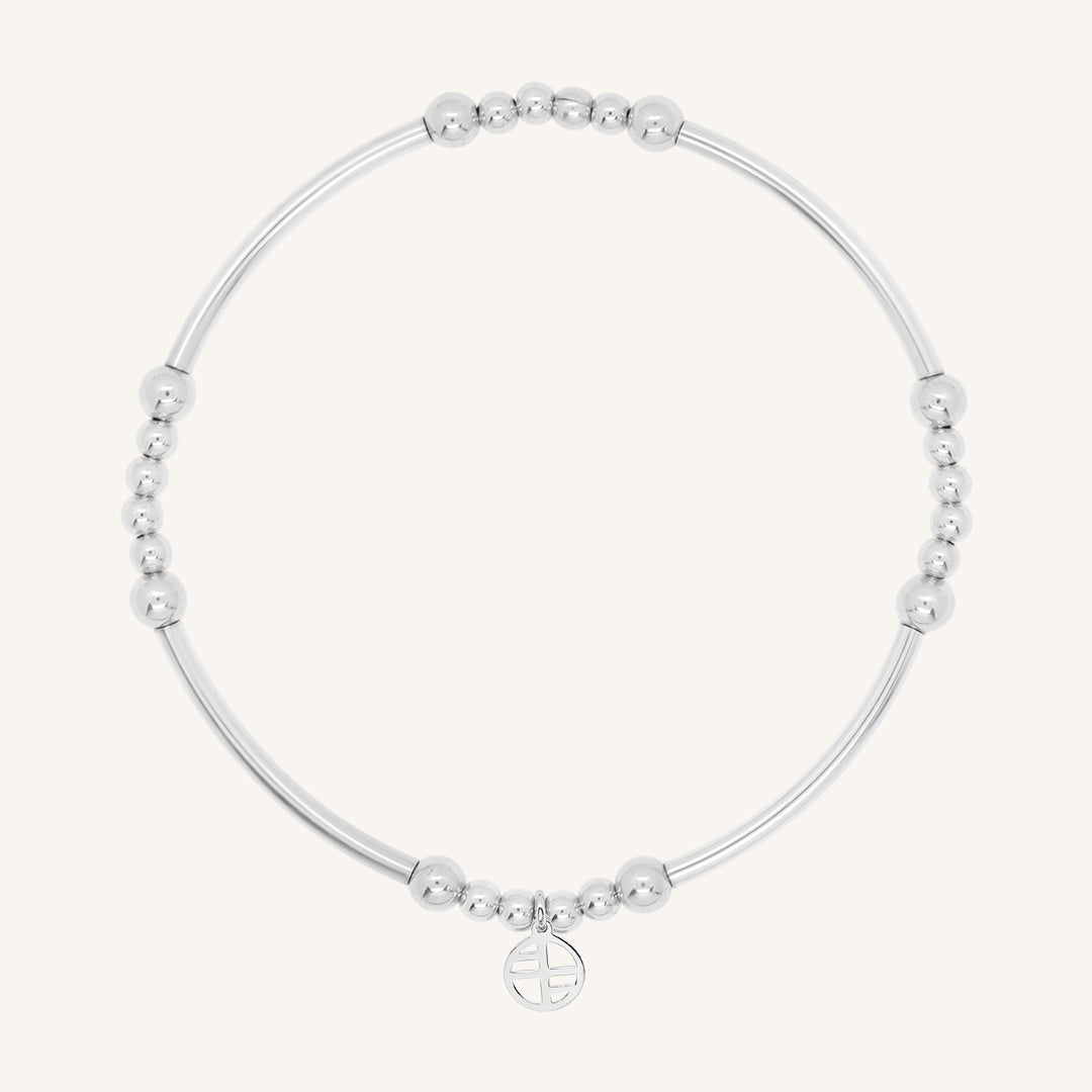 A silver bracelet with spherical beads and a Francesca logo
