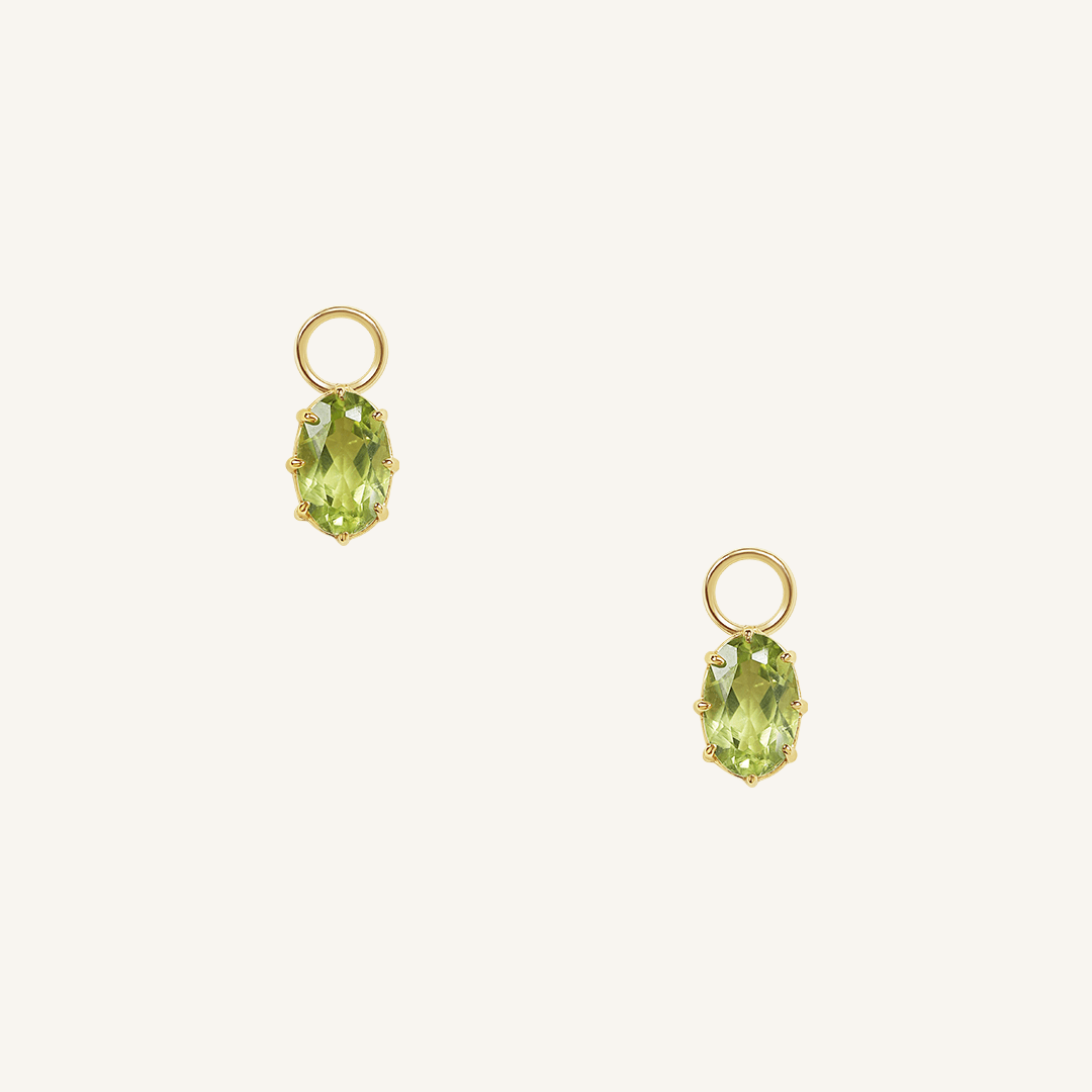 A set of two gold hoop charms with olive green stones, isolated on a white background.