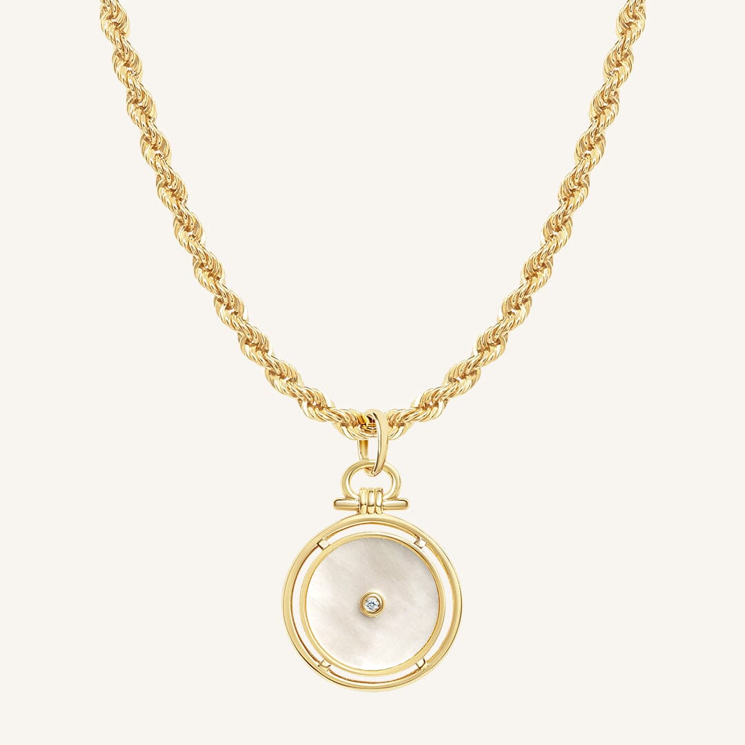 Gold necklace with a circular pendant on a white background