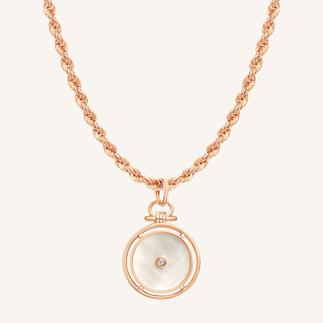 Rose gold necklace with a circular pendant on a white background