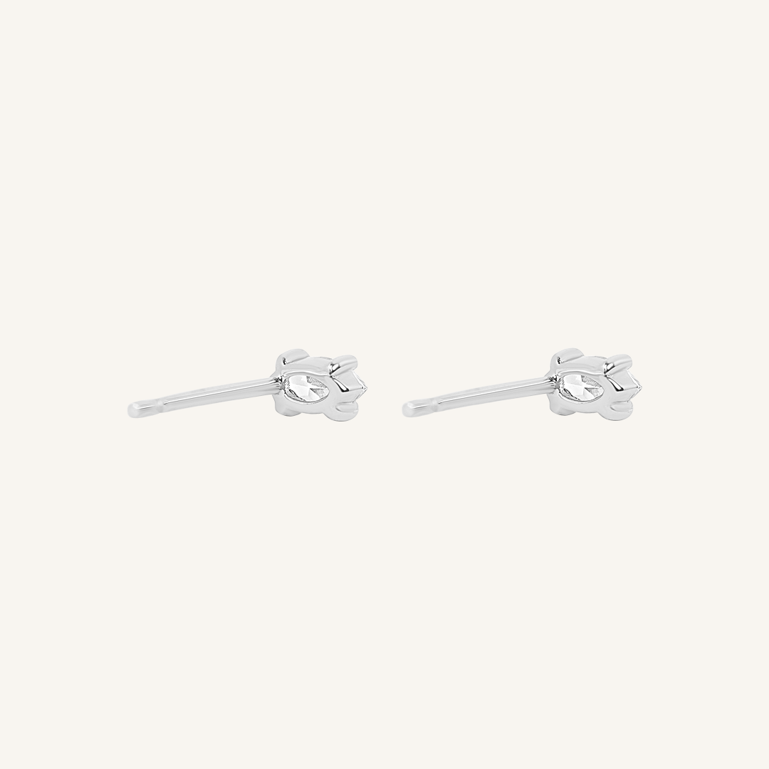 A pair of stud earrings with clear cubic zirconia set in silver metal, presented against a white background.
