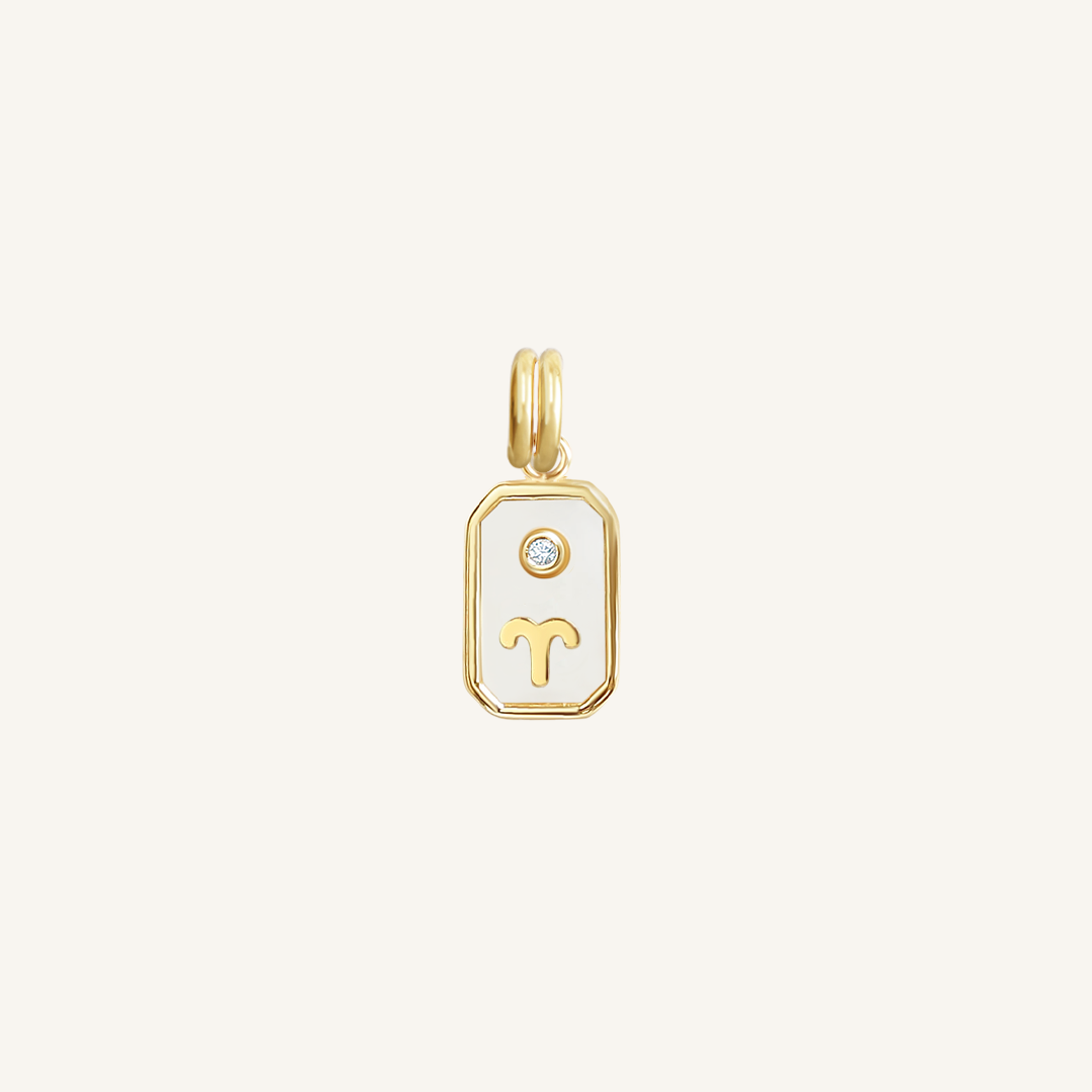 A gold rectangular shaped charm with the Aries zodiac symbol on it, designed with an iridescent finish.