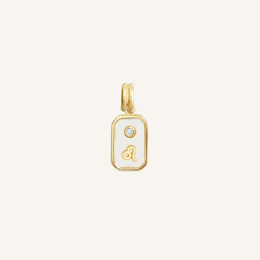 A gold rectangular shaped charm with the Leo zodiac symbol on it, designed with an iridescent finish.