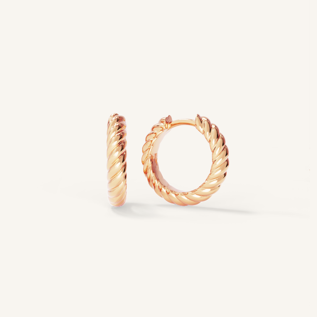 rose gold delicate hoops with a twist design on white background