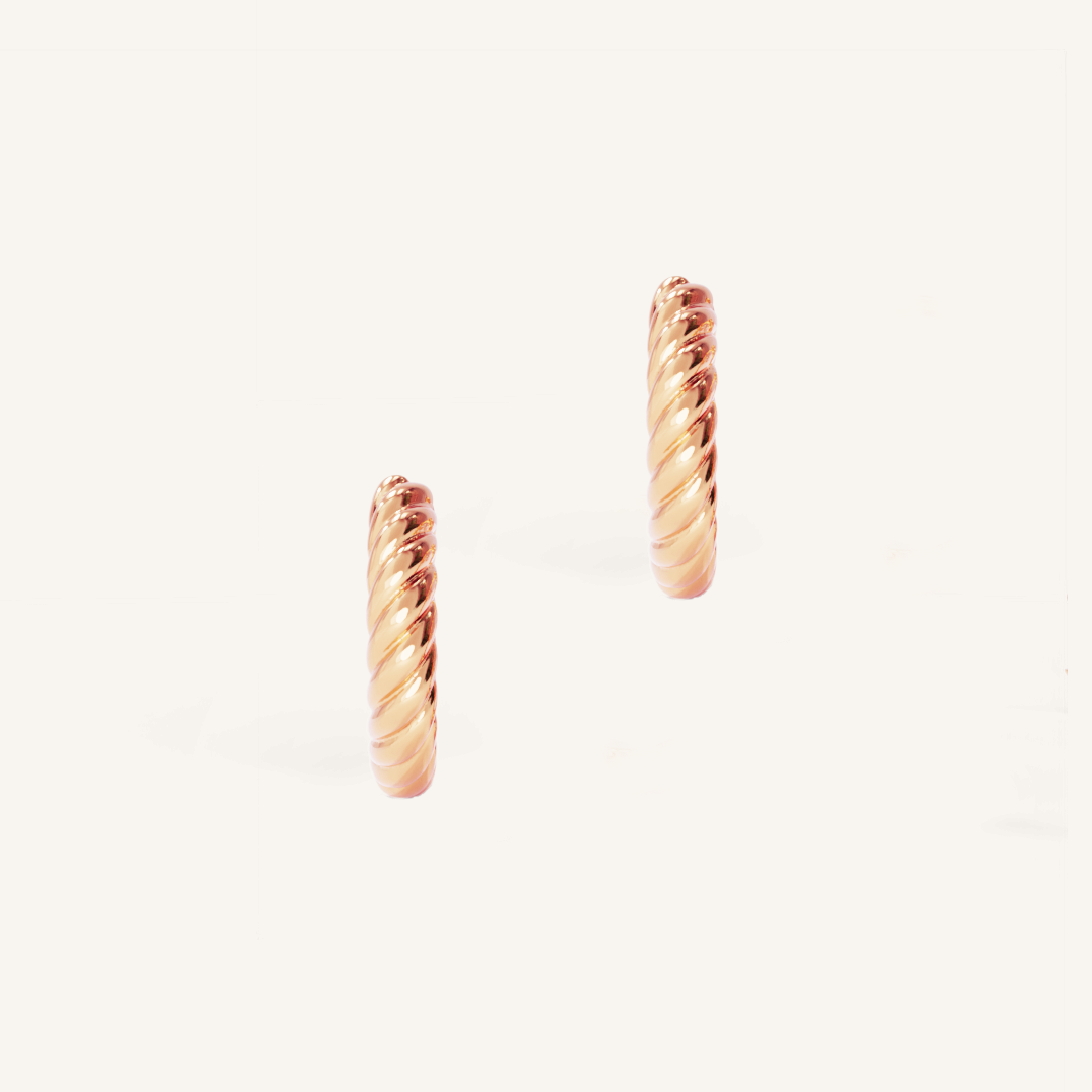 rose gold delicate hoops with a twist design on white background