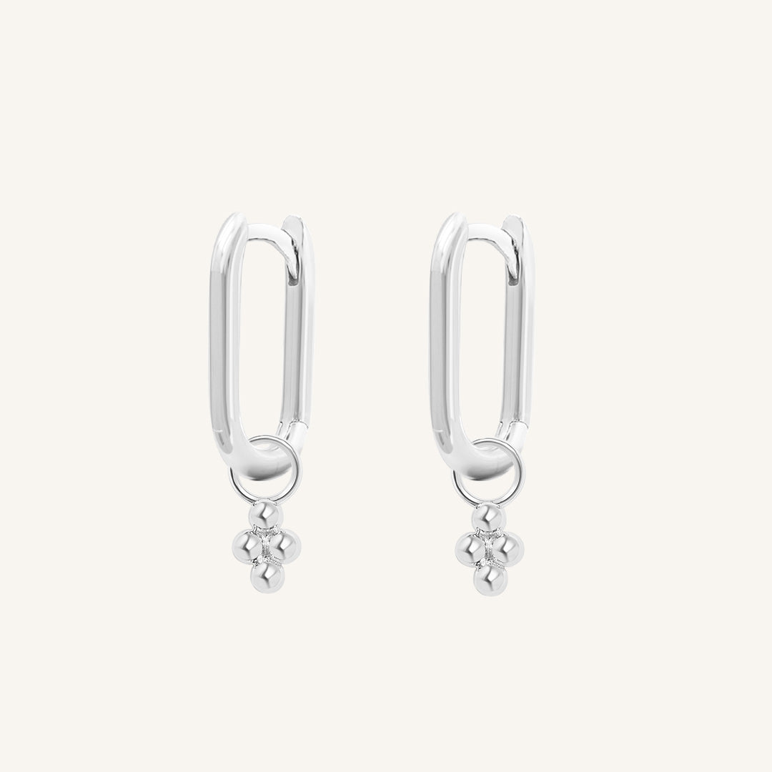 A pair of silver-colored rectangle hoop earrings with petite bobble details.