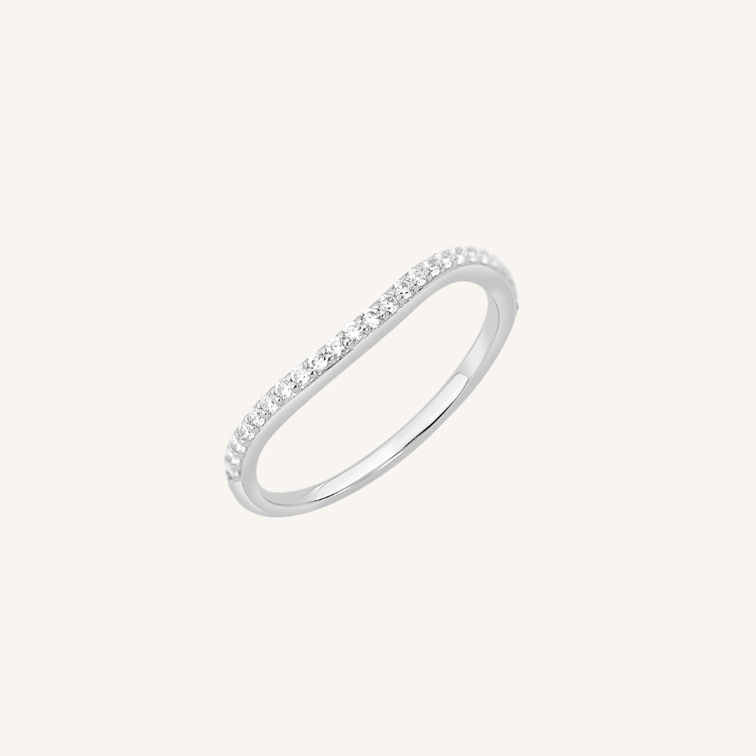 A slim, elegant ring with multiple small cubic zirconias set in a silver coloured band.