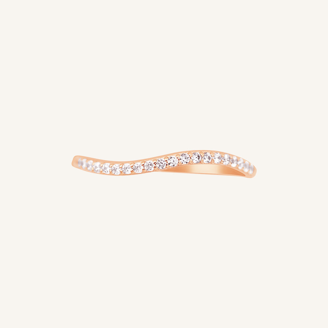 A slim, elegant ring with multiple small cubic zirconias set in a rose gold coloured band.