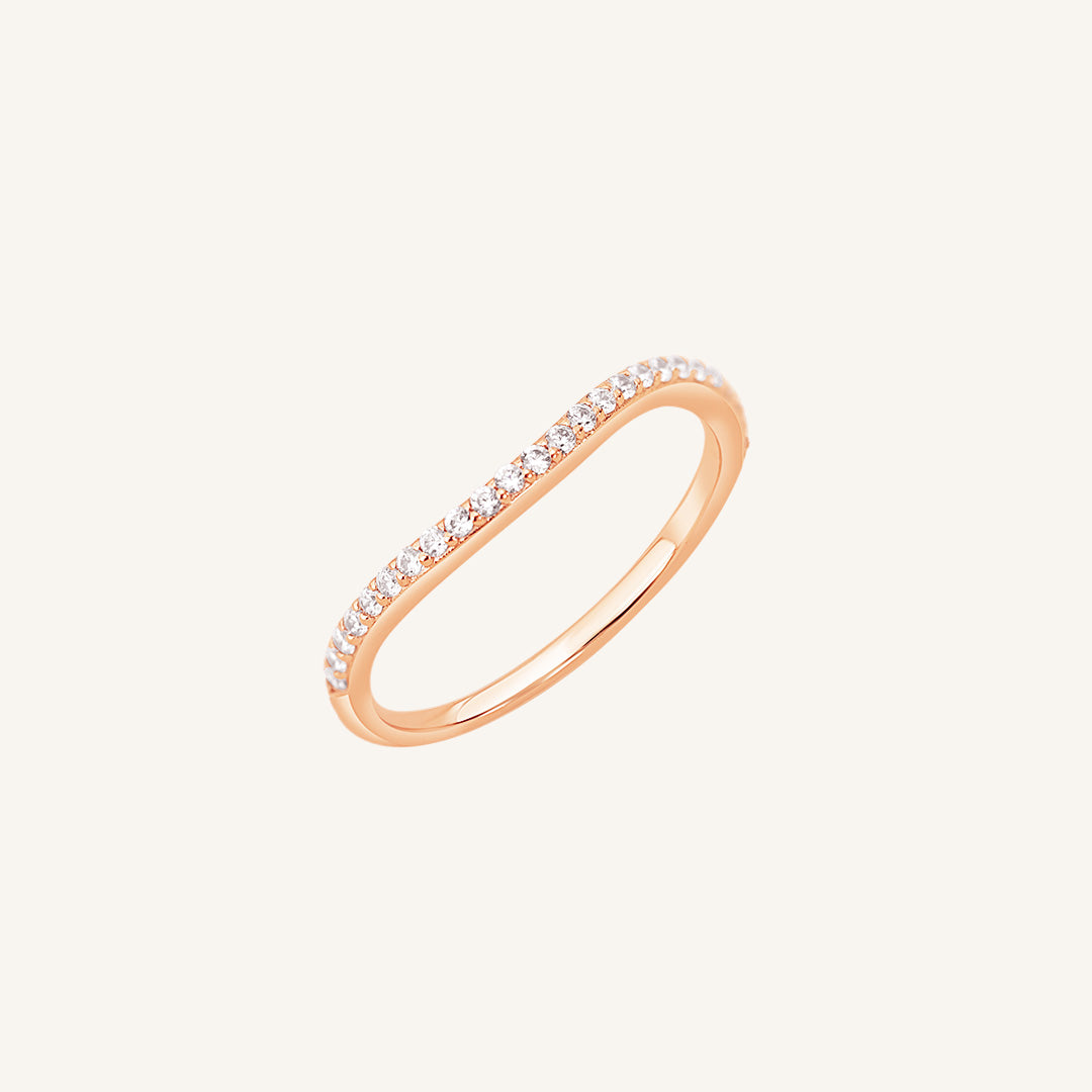 A slim, elegant ring with multiple small cubic zirconias set in a rose gold coloured band.