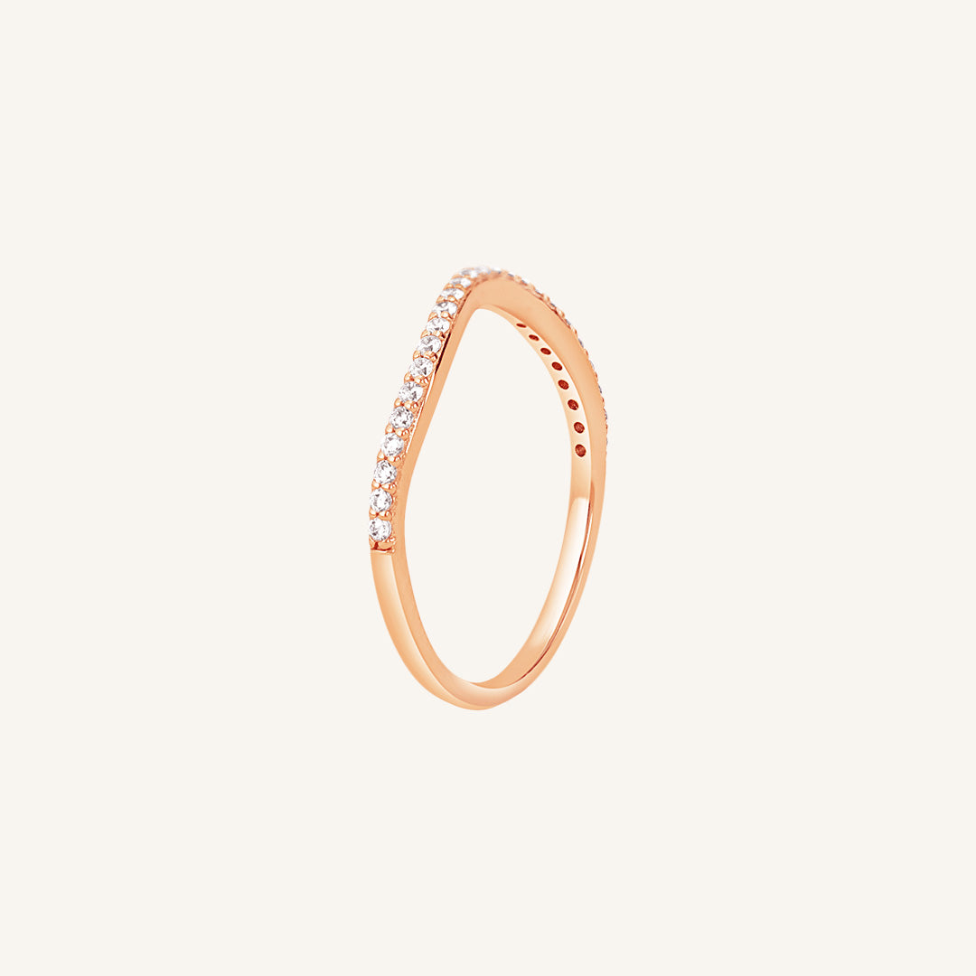 A slim, elegant ring with multiple small cubic zirconias set in a rose gold coloured band.