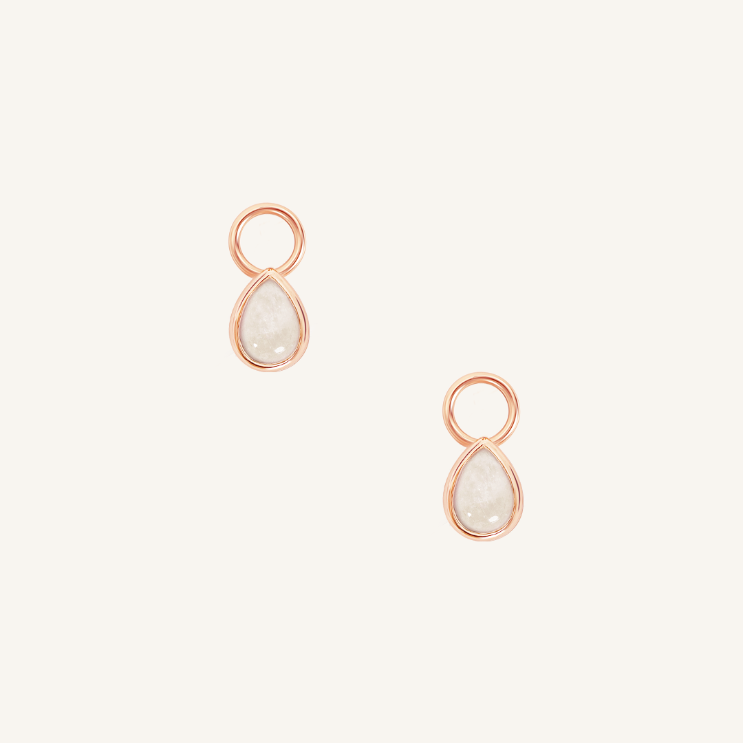 A set of two rose gold hoop charms with teardrop-shaped Moonstone stones